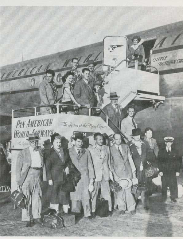 1949 In Tokyo passenger pose on the aircraft steps.  Though already serving Tokyo for several years these customers were the first to arrive in Tokyo aboard the then new double decked Boeing 377 